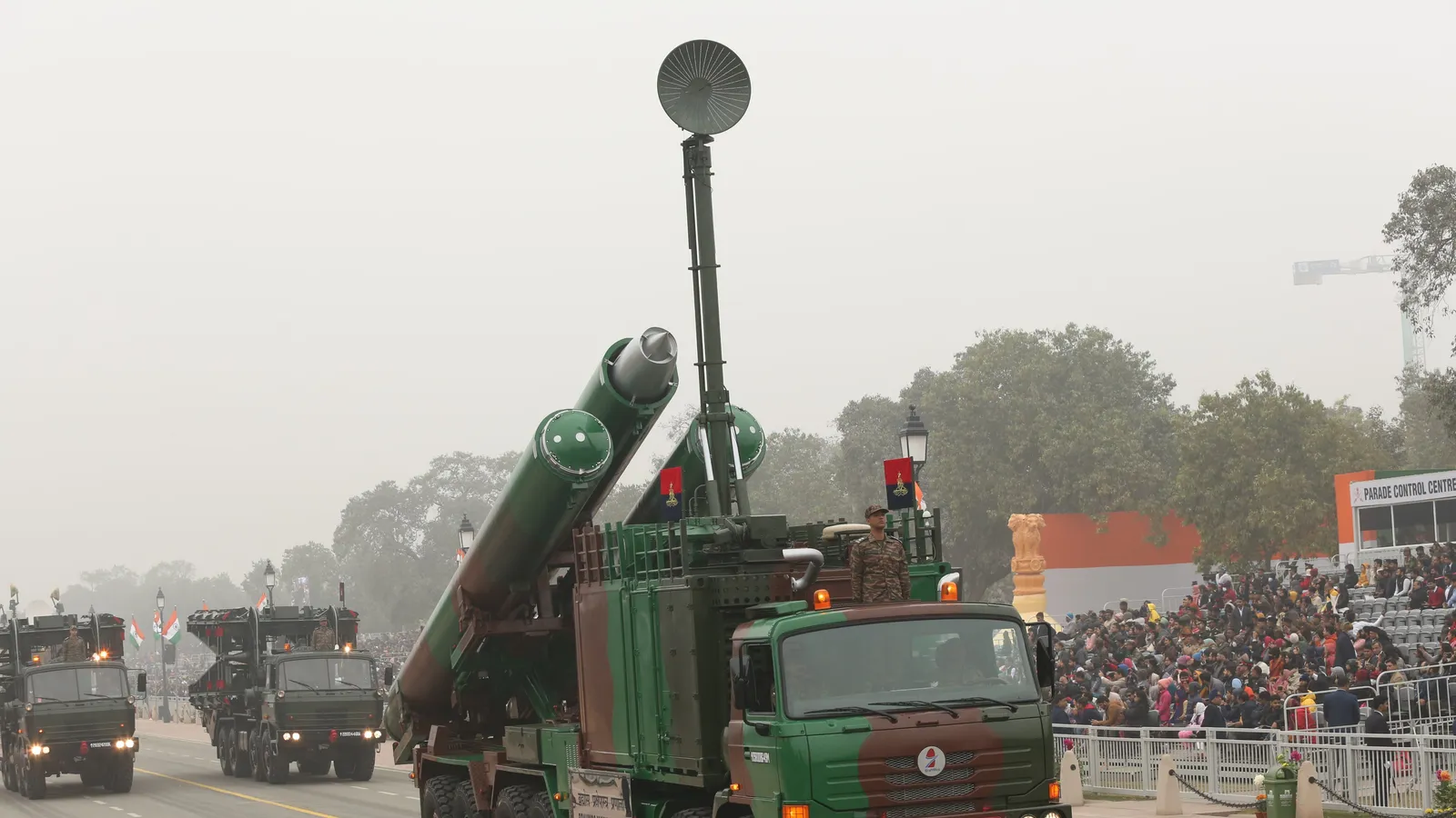 An Indian Army BrahMos mobile autonomous launcher with its missile canisters raised drives down Kartavya Path during the 74th Republic Day parade in New Delhi, with more launcher vehicles following and spectators watching from the stands.
