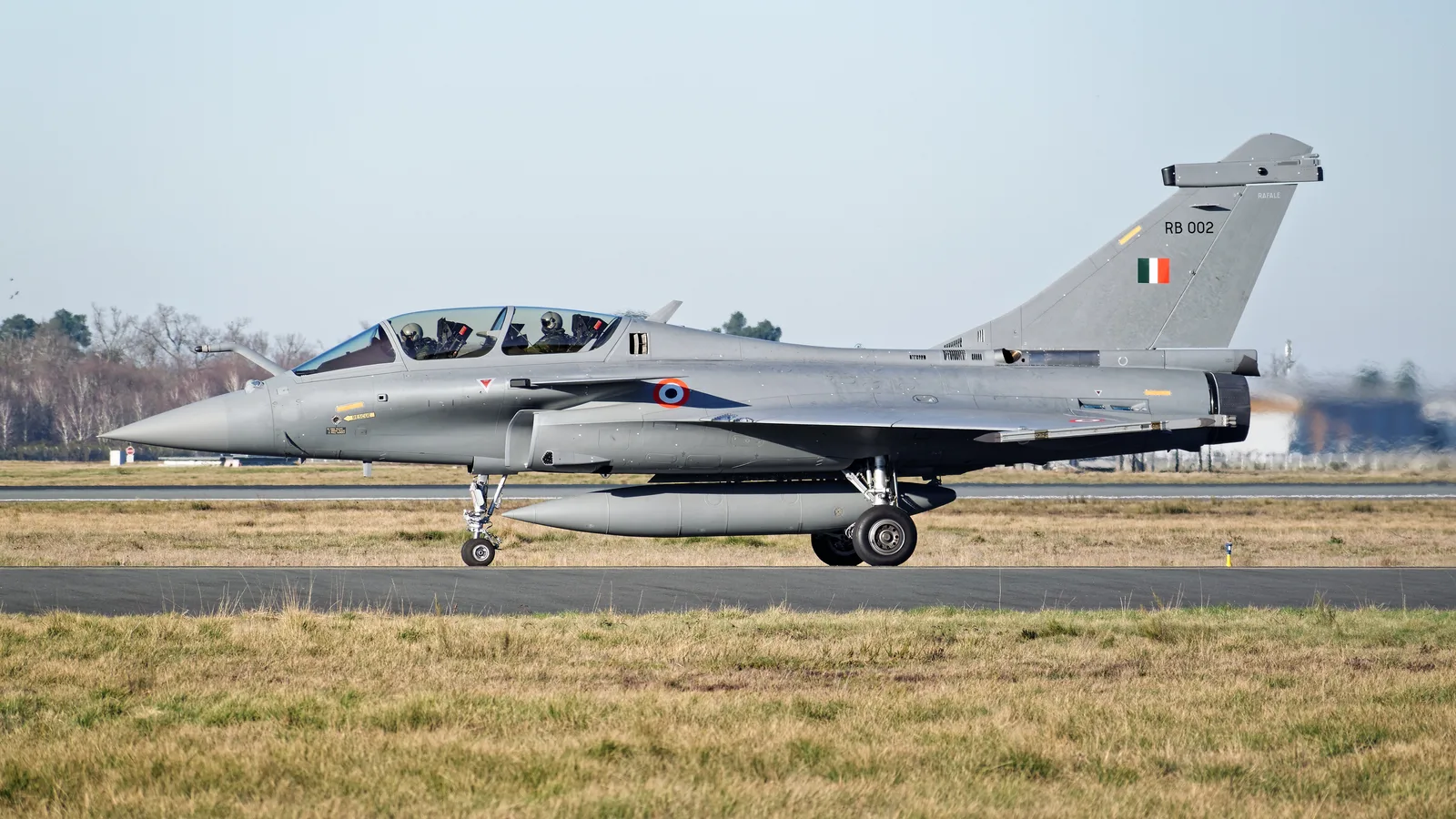 An Indian Air Force Rafale, tail number RB 002, taxiing with its roundel and fin flash clearly visible.