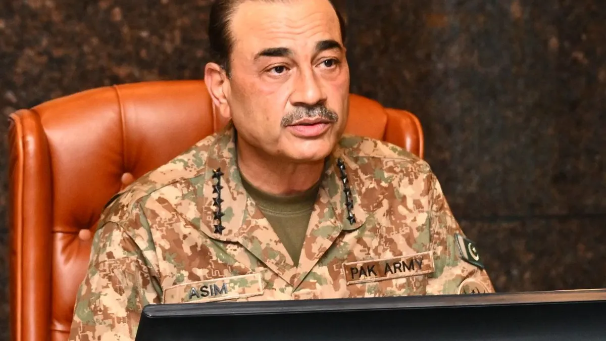 Pakistan Army chief Field Marshal Asim Munir, in combat uniform with name and Pak Army patches, seated in a leather chair at a conference table during the Corps Commanders' Conference at General Headquarters, Rawalpindi.