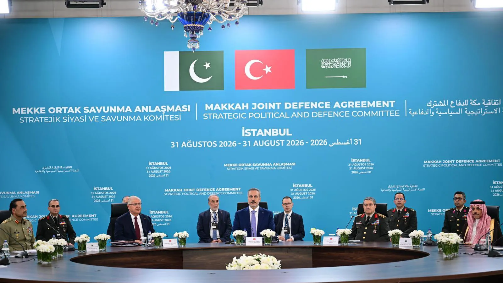 Turkish Foreign Minister Hakan Fidan seated at the centre of the head table, flanked by Turkish, Pakistani and Saudi ministers and uniformed military chiefs, beneath the Pakistani, Turkish and Saudi flags and the Makkah Joint Defence Agreement backdrop at the first Strategic Political and Defence Committee meeting in Istanbul, 31 August 2026.
