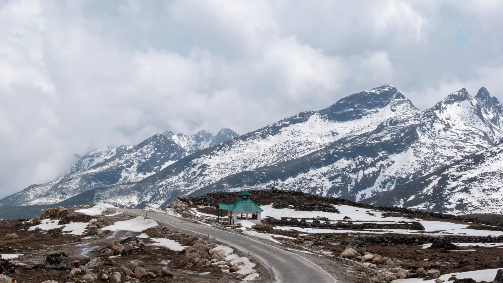 Snow-streaked high Himalayan ridgelines under heavy cloud near Bum La Pass on the India-China Line of Actual Control in Arunachal Pradesh.