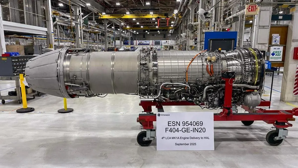 A GE F404-IN20 engine on a red transport stand at a GE Aerospace facility, placarded as the fourth LCA Mk1A engine delivery to HAL.